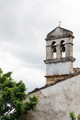 Fototapeta na wymiar Rustic church bells in an old town in Tuscany, Italy