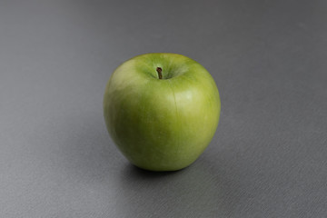 still life ripe fresh green granny apple on a gray background
