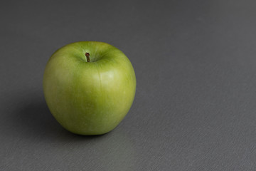 still life ripe fresh green granny apple on a gray background