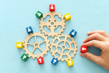 image of colorful blocks with people icons over wooden table ,human resources and management concept
