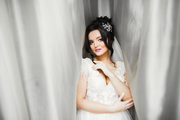 Portrait of stunning bride with long hair posing with great bouquet