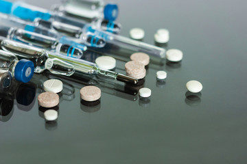 Thermometer, pills, injection vaccine ampoules, syringe on glass background, Coronavirus, MERS-CoV,...