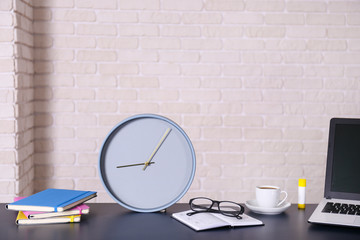 Creative workspace of a blogger. White laptop computer on wooden table in loft style office with brick walls. Designer's table concept. Close up, copy space, background.