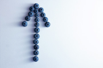 arrow shape from ripe blueberries on a white background