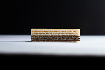crispy waffle with cream and chocolate filling on a white background