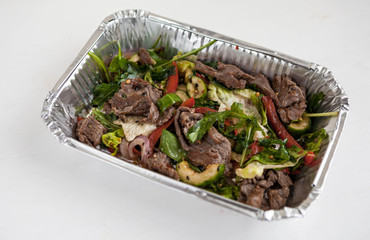 Food delivery. Beef Salad. Healthy food delivery.