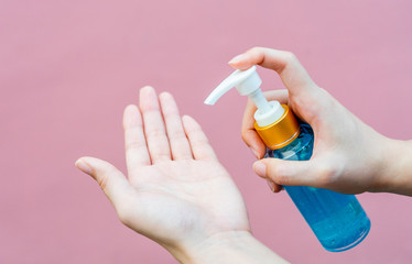 Hands using alcohol gel as hand sanitizer for prevent the spread of germs and bacteria and avoid infections corona virus. Hygiene concept