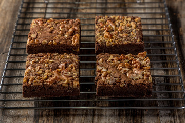 homemade brownie in squares on wood