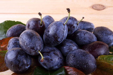 Blue plums on table