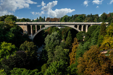 Fototapeta na wymiar The bridge of Adolf (New Bridge) - a bridge in the city of Luxembourg, (built 1900-1903). The bridge connects Upper and Lower Town: two parts of Luxembourg.