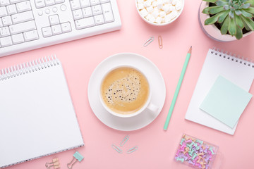Woman office workplace with cup of coffee and pastel colorful stationery accessories on pink background. Top view - 344590114