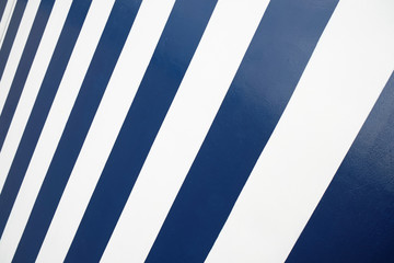 Empty surface with broad diagonal dark blue and white stripes.