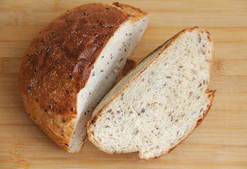 fresh bread with flax cut on a wooden Board