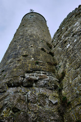 McCarthy's Tower viewed from the base in the medieval monastery of Clonmacnoise, during a rainy summer day.