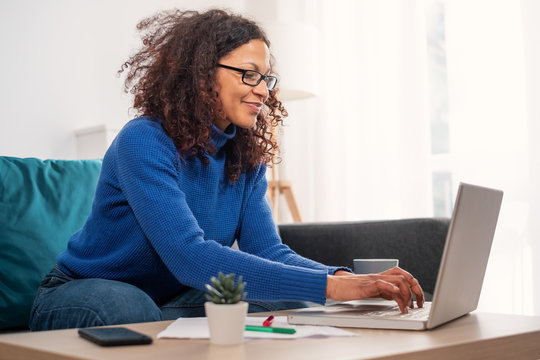 One Black Woman Working From Home Using Laptop