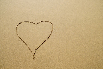 Fototapeta na wymiar Elegant heart symbol on sand, backdrop with space for text.