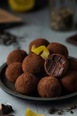 Close-up of chocolate truffles with black pepper and lemon zest