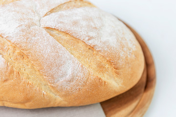 White handmade bread on a wooden board. Healthy eating Close-up. Space for text. White background.