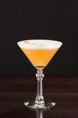 Alcohol Cocktail with Egg White, Fruits and Decorations Close Up on Dark Background. 