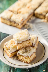 mini coconut cake with dulce de leche cut into squares ready to eat