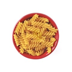 Fusilli noodles in a red bowl Isolated on white background.