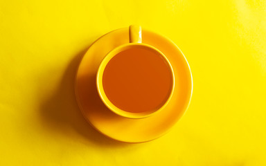 Obraz na płótnie Canvas Top view image of coffe cup on yellow background. Flat lay. Copy space