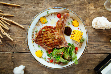 Appetizing juicy pork chop with a corn