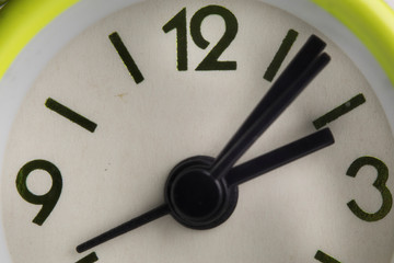 close up or macro photo of the analog alarm clock with hour and minute hand.