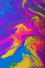 Colorful marble background.Mixed polishes-yellow,pink,blue and purple.Colorful marble background.Beautiful stains of liquid nail polish,fluid art technique.Pour painting technique.Vertical banner.