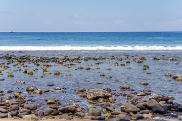 View on Indian ocean coast with pebble and sand beach on Bali, Indonesia