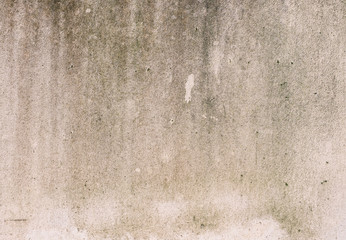 Old dirty concrete wall with the moss stains.