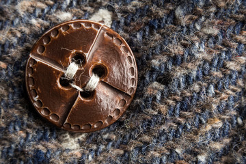 Obraz na płótnie Canvas macro or close-up photo of the vintage shirt button. the focus on the button. this is textile, texture, or tissue concepts. It could be used as also background, wallpaper, abstract concept.