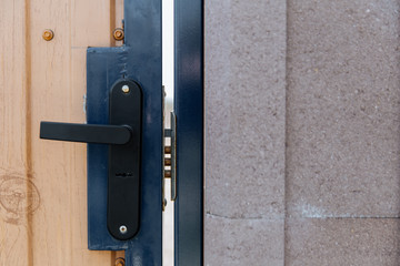 Detail of a closed door with a lock handle.