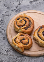 Tasty buns with raisins on a grey concrete table. fresh bakery. breakfast. bread. top view