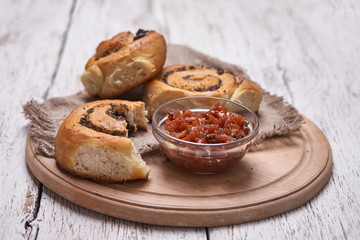 Tasty buns with raisins on a white rustic wooden table. fresh bakery. breakfast. bread. top view