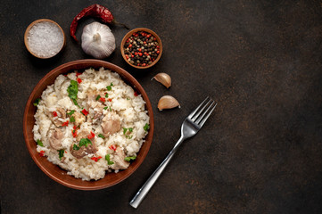 Homemade pilaf with meat and spices in a bowl on a stone table with copy space for your
 text. Oriental cuisine.