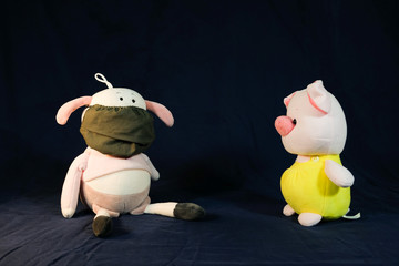 Pigs puppets with a protection mask on the mouth. Coronavirus style.