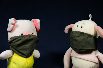 Pigs puppets with a protection mask on the mouth. Coronavirus style.