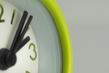 close up or macro photo of the analog alarm clock with hour and minute hand.