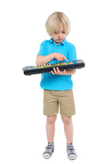 Boy plays on toy guitar isolated on white