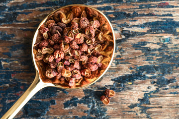 Szechuan Peppercorns on a Gold Spoon