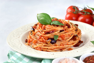 Pasta with tomato sauce, sun-dried tomatoes and olives