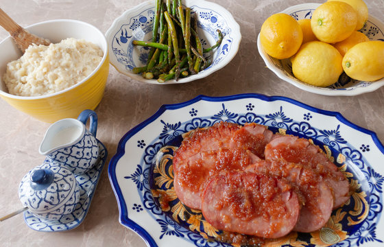 Turkey Ham Dinner Served on Blue and Yellow Dishes