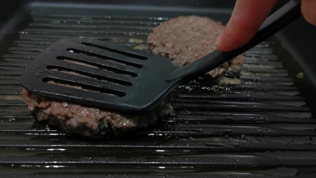 Grilled burgers toasting process. Kitchen concept.