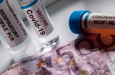 Coronavirus vial on euro banknotes, conceptual image