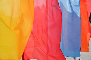 Bright multicolored vertical flags on flagpoles
