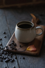 A cup of black coffee on a wooden table