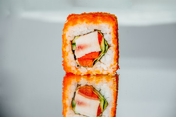Sushi roll on a mirror table with reflection - 344613941