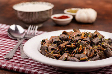 broad beans with traditional turkish food cooked together with spices on brown background