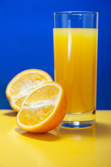 Оrange juice on a blue and yellow background